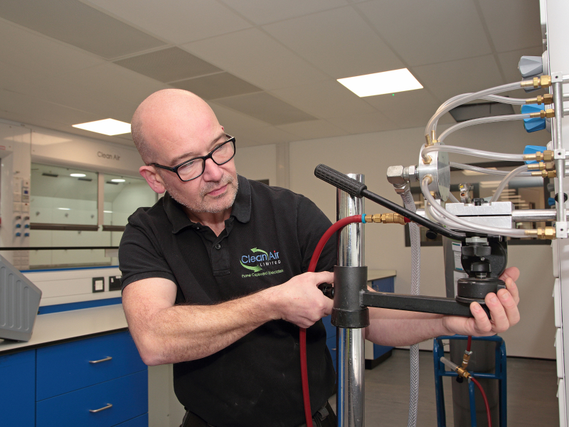 Engineer servicing fume cupboard
